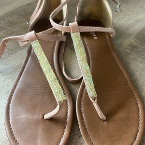 Elegant pink sandals with brown soles and glitter strap